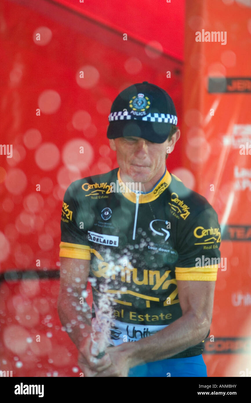 Professional cyclist spraying champagne after win in city circuit in 2005 Tour Down Under Adelaide Australia in vertical format Stock Photo