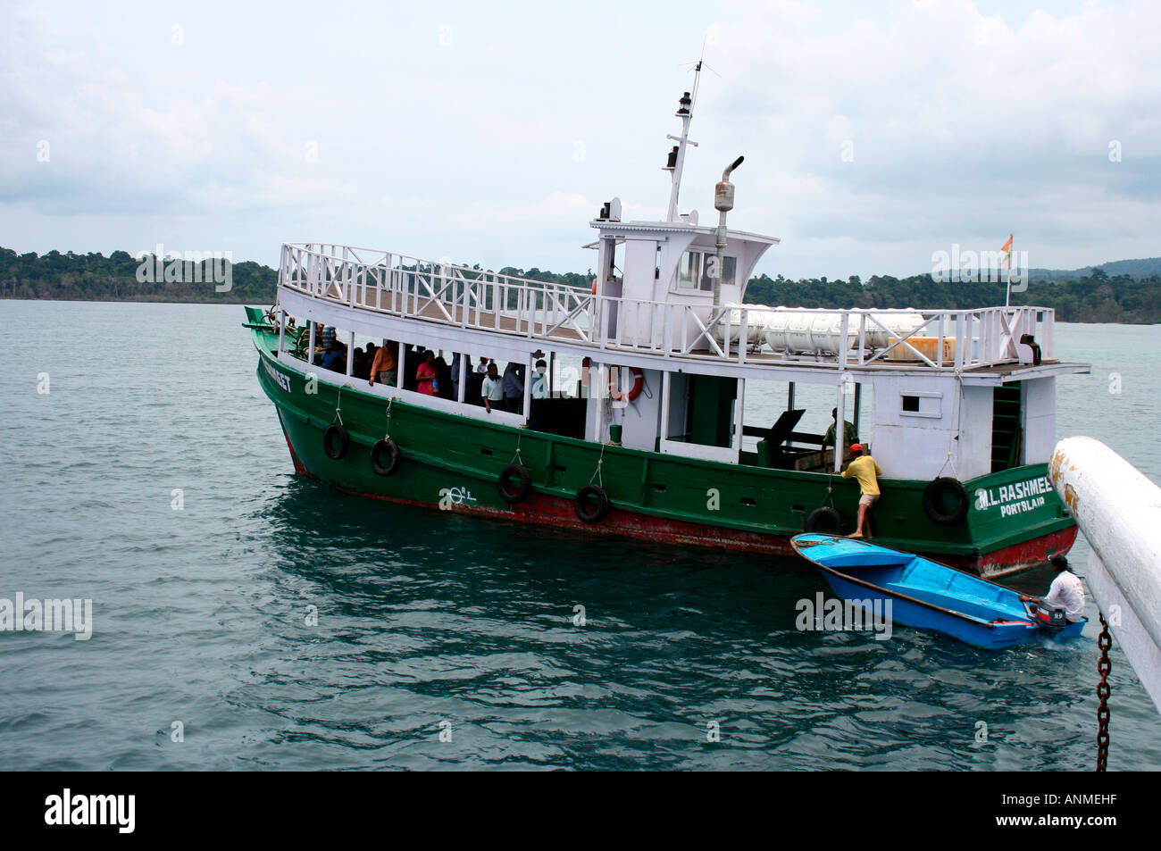 A small boat beside a bigger boat which transports passengers from ship to the Jolly buoy beach Andaman Stock Photo