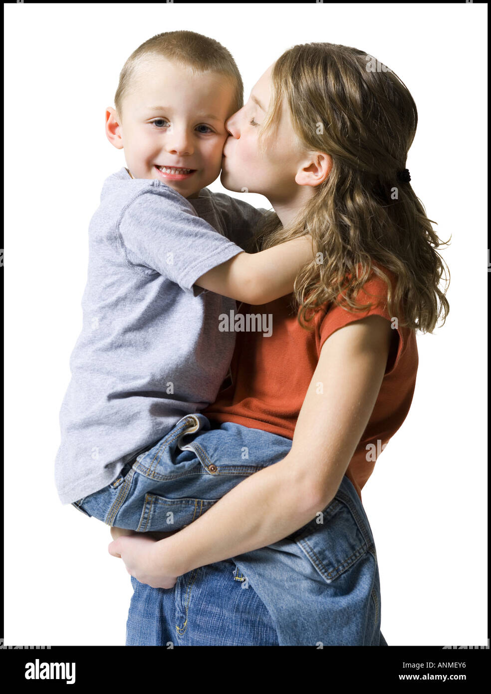 Profile of a sister kissing her brother Stock Photo