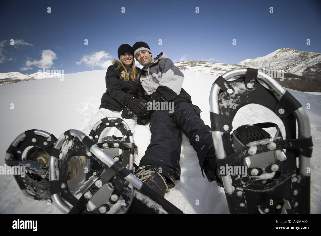 Portrait of a young couple wearing snowshoes Stock Photo