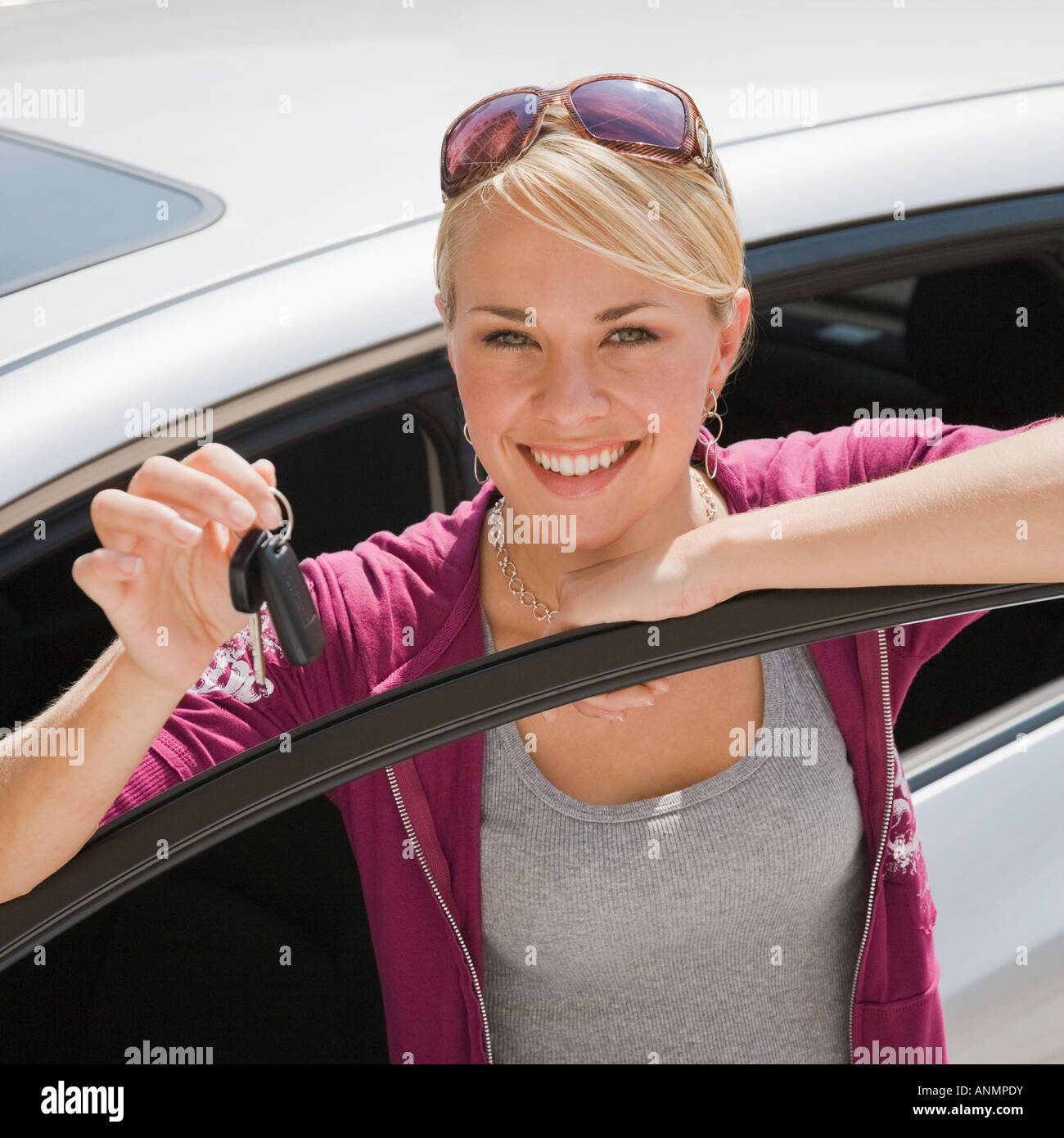 Young woman holding keys to new car Stock Photo - Alamy
