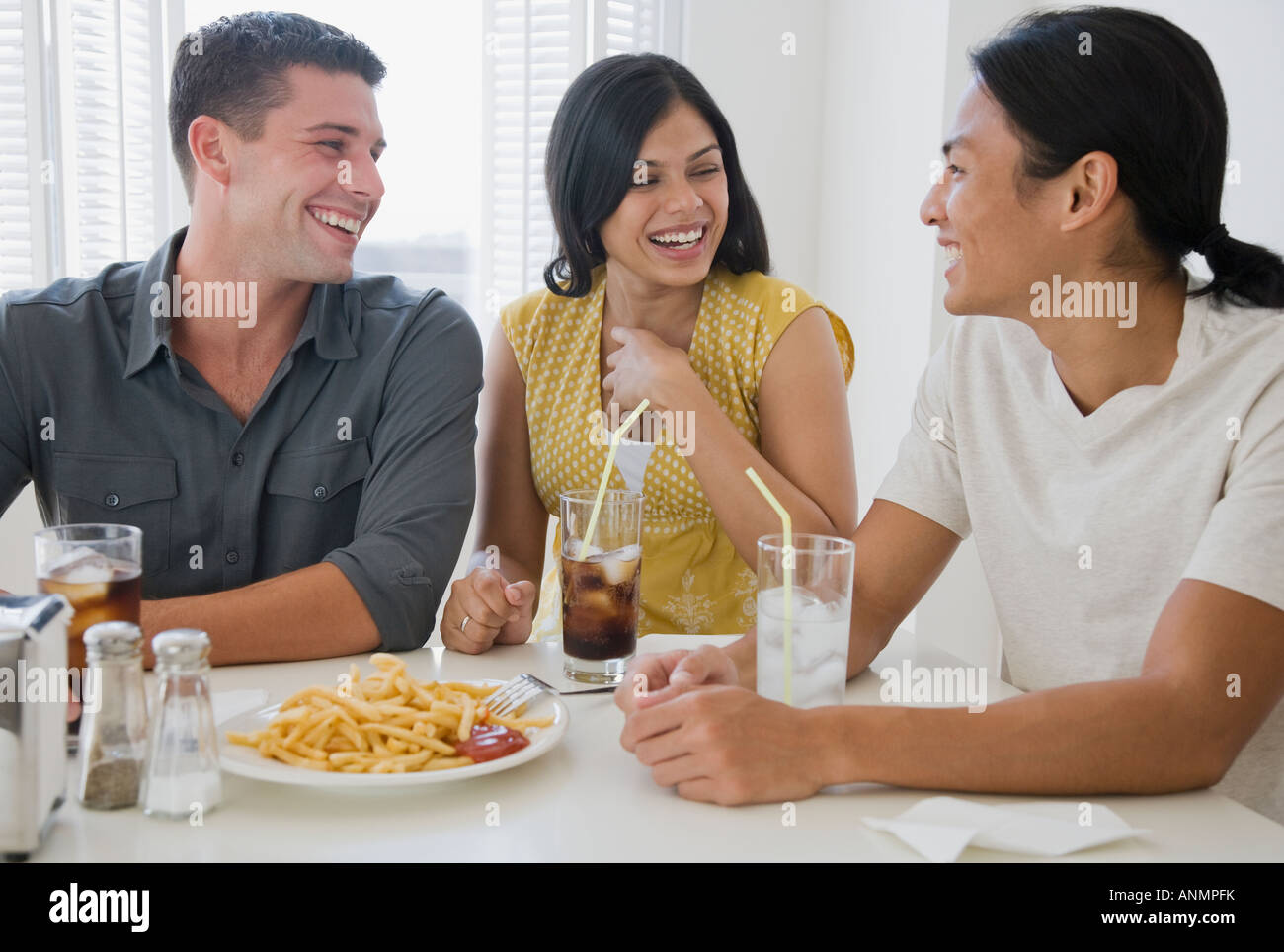 Multi-ethnic friends eating at diner Stock Photo