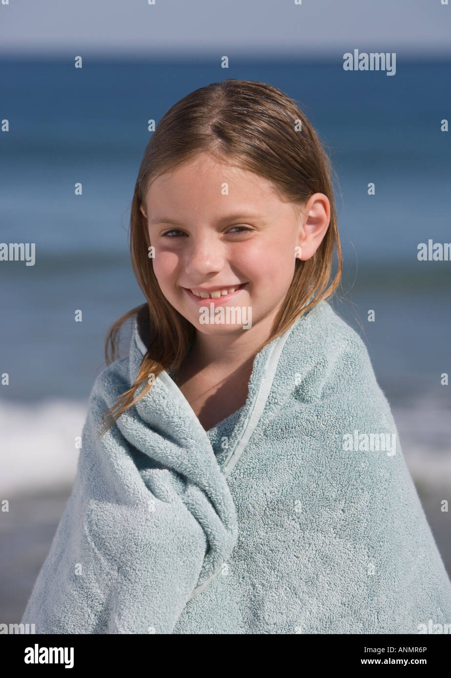 Girl wrapped in beach towel Stock Photo Alamy