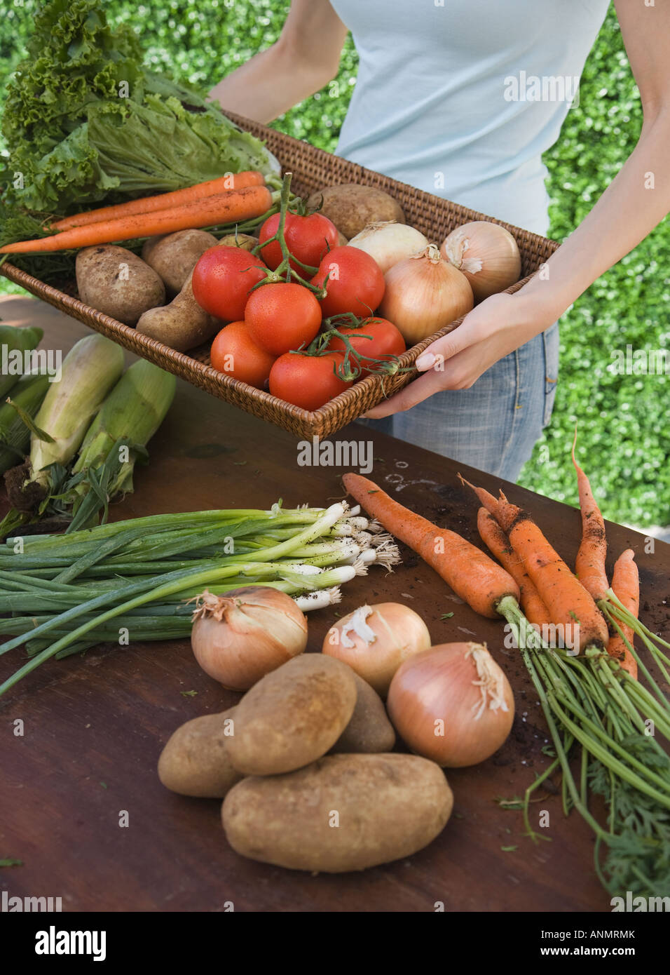 Woman holding basket of fresh vegetables Stock Photo - Alamy