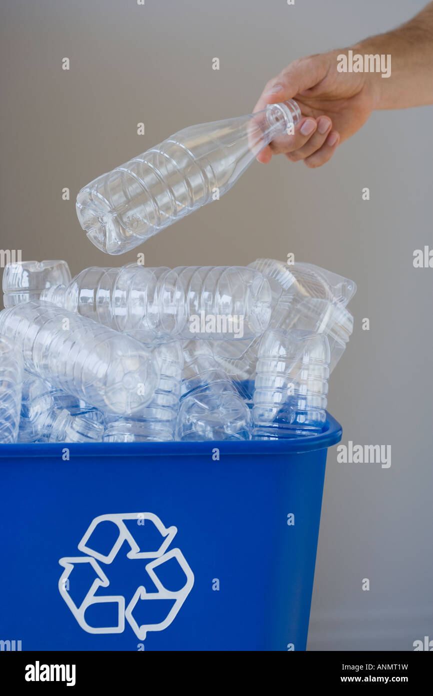 Man putting bottle in recycling bin Stock Photo Alamy