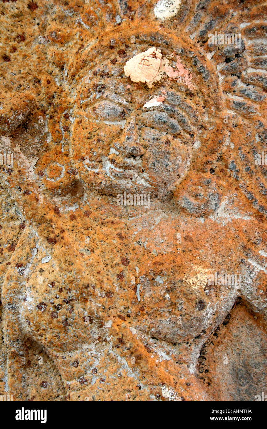 Close up the sculpture of a female demon on stone at a temple in Tamil Nadu Stock Photo
