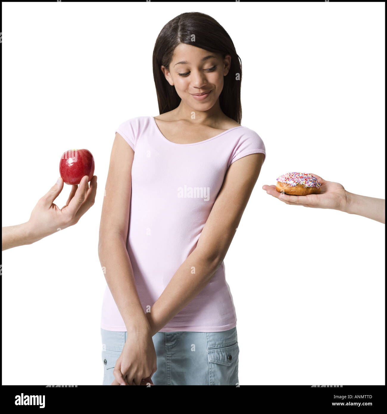 Close up of two peoples hand s offering food to a girl Stock Photo