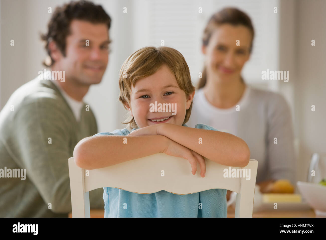 Boy sitting backwards in chair Stock Photo Alamy