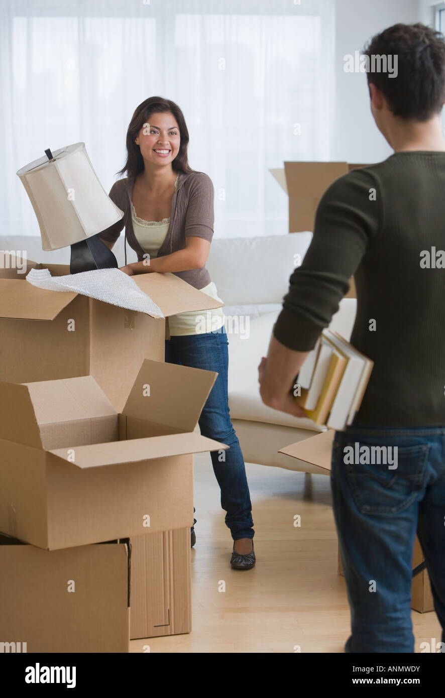 Multi-ethnic couple packing moving boxes Stock Photo
