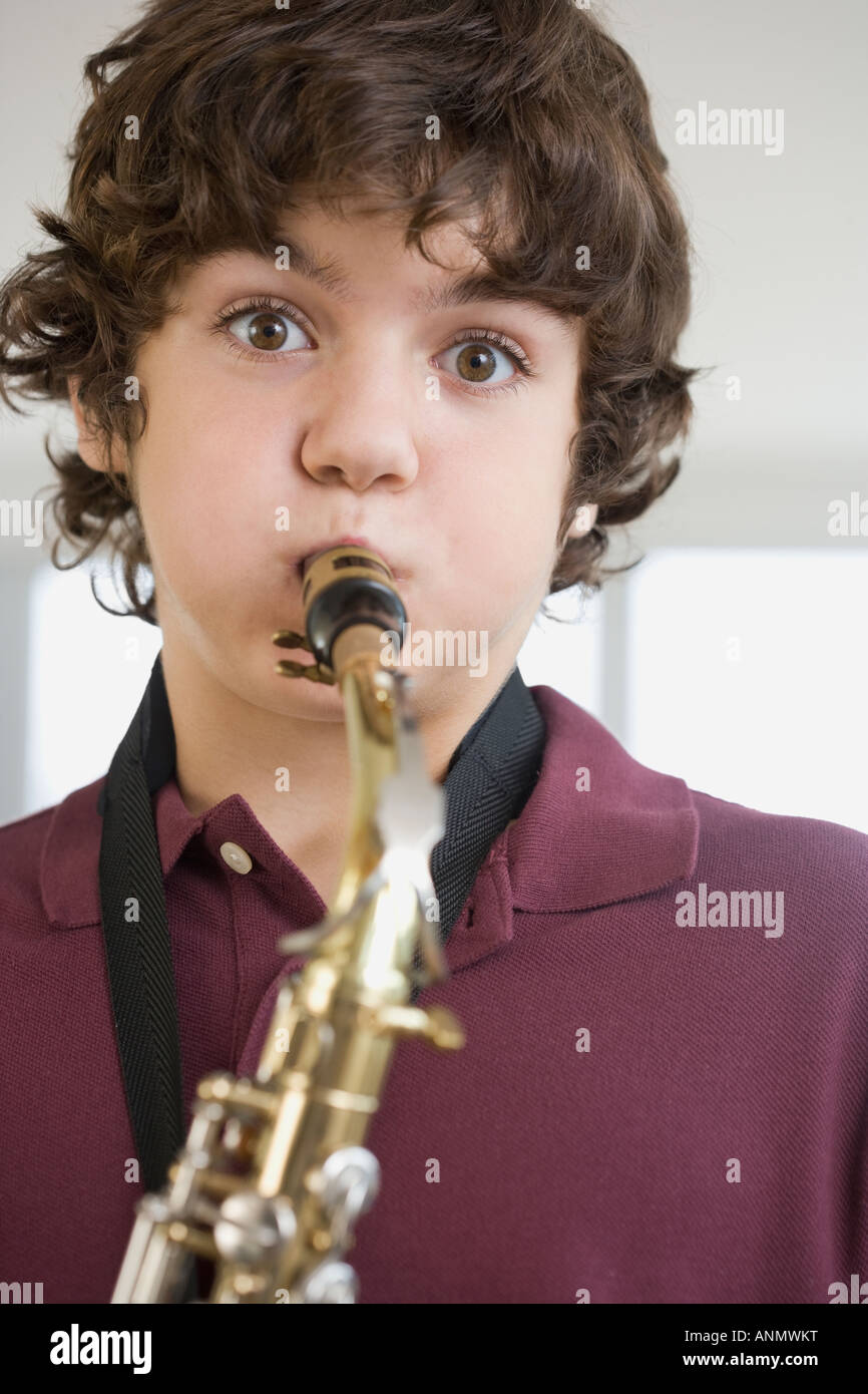 Boy playing saxophone hi-res stock photography and images - Alamy