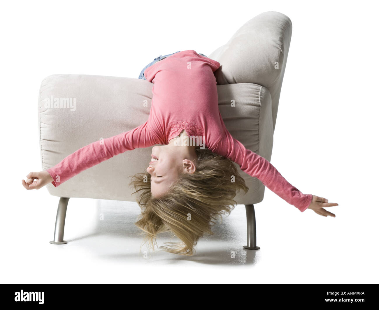 Girl lying upside down on a couch Stock Photo Alamy