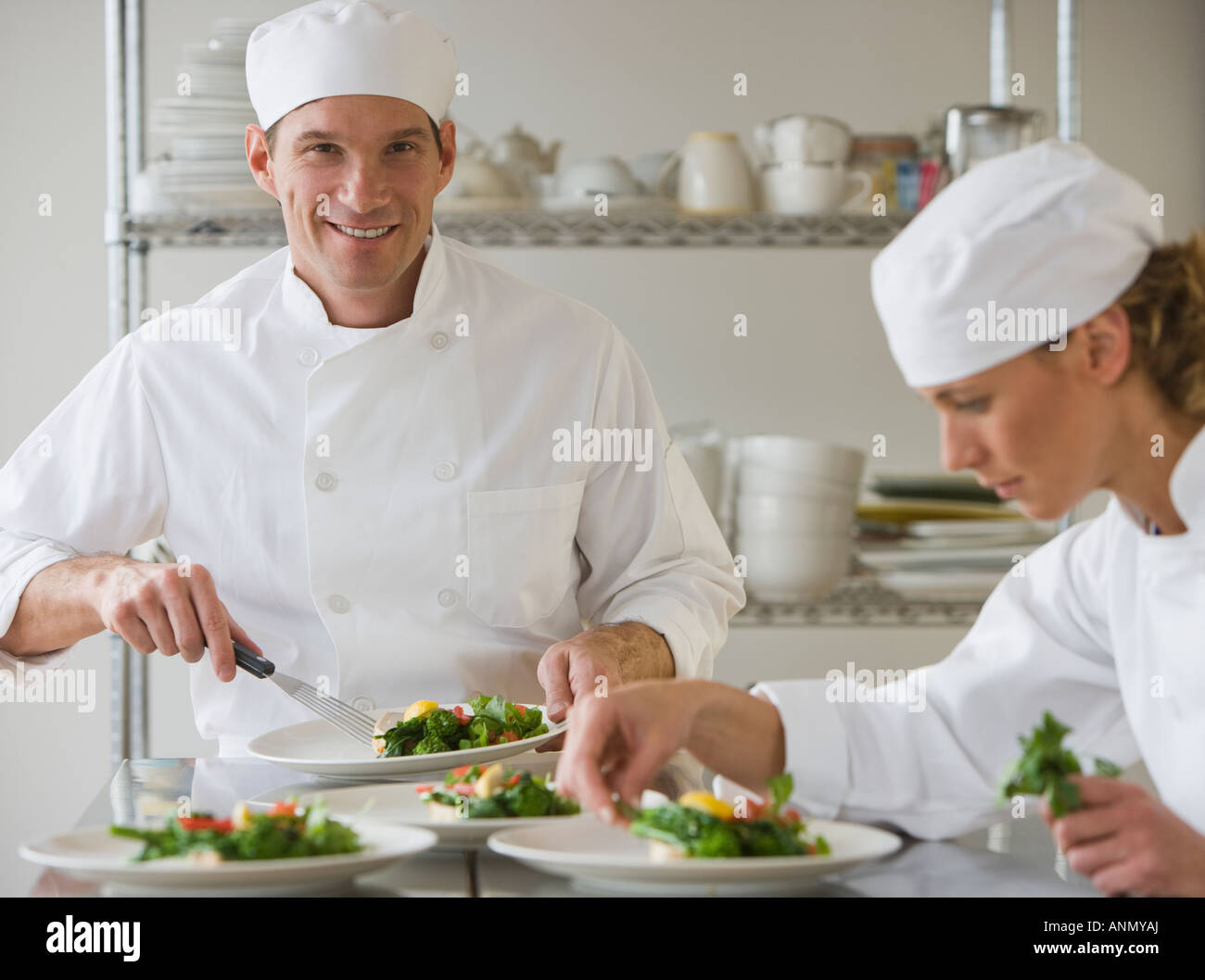 Male and female chefs plating food Stock Photo