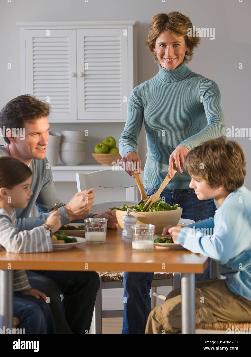 Family eating at dinner table Stock Photo - Alamy