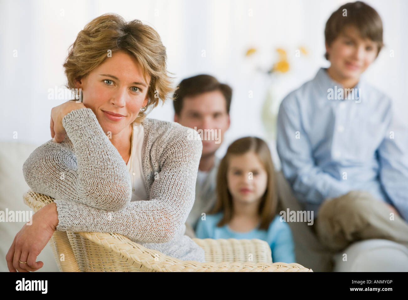 Woman in front of family Stock Photo