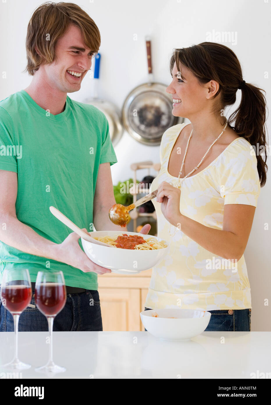 Couple preparing food in kitchen Stock Photo
