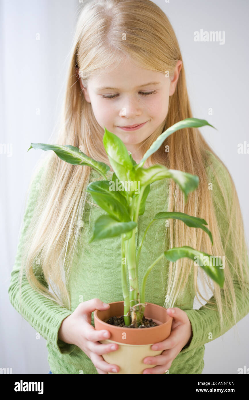 Girl holding potted plant Stock Photo - Alamy