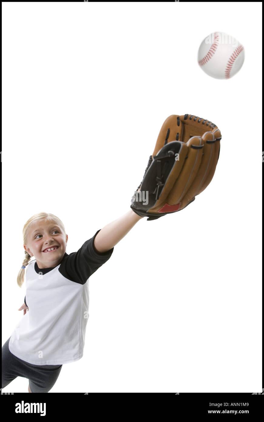 Low angle view of a girl catching a baseball Stock Photo - Alamy