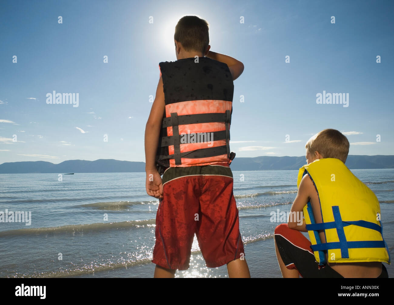 Boys in life jackets looking out over lake, Utah, United States Stock Photo Alamy
