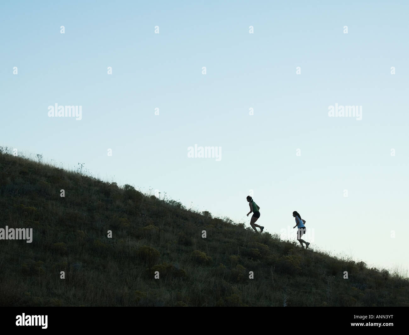 People running up mountain, Salt Flats, Utah, United States Stock Photo