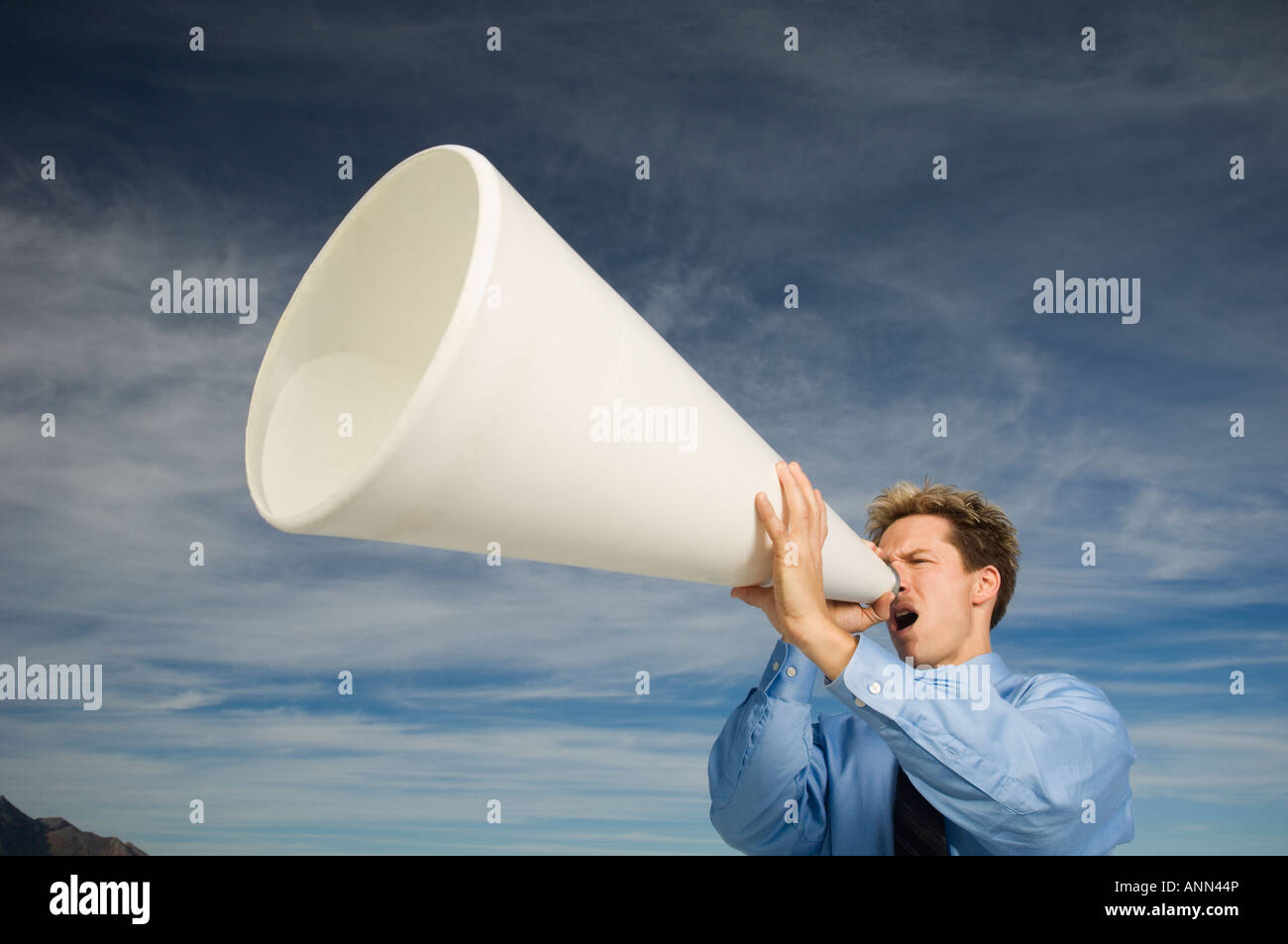 Businessman yelling into megaphone, Salt Flats, Utah, United States