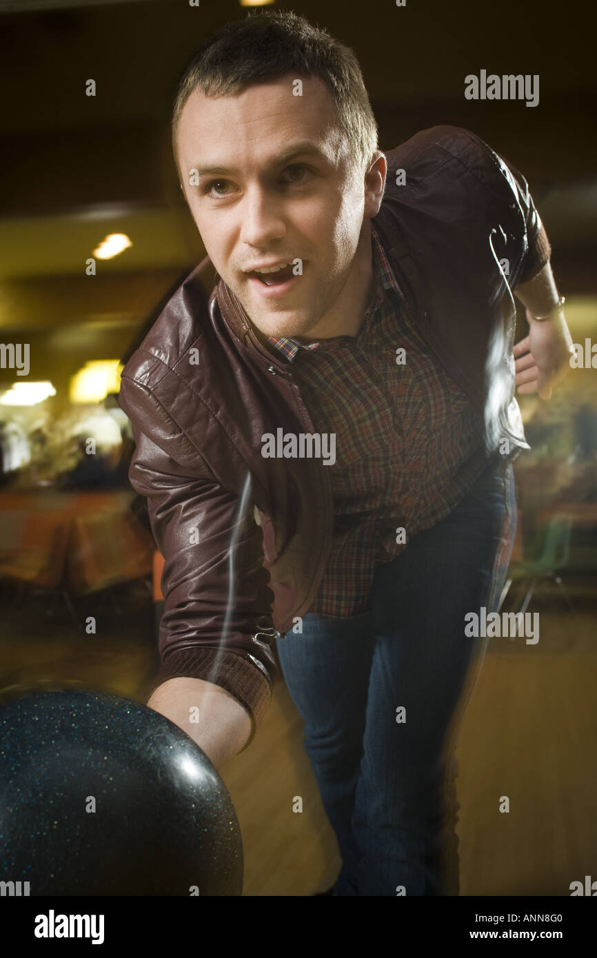 Young man bowling in a bowling alley Stock Photo Alamy