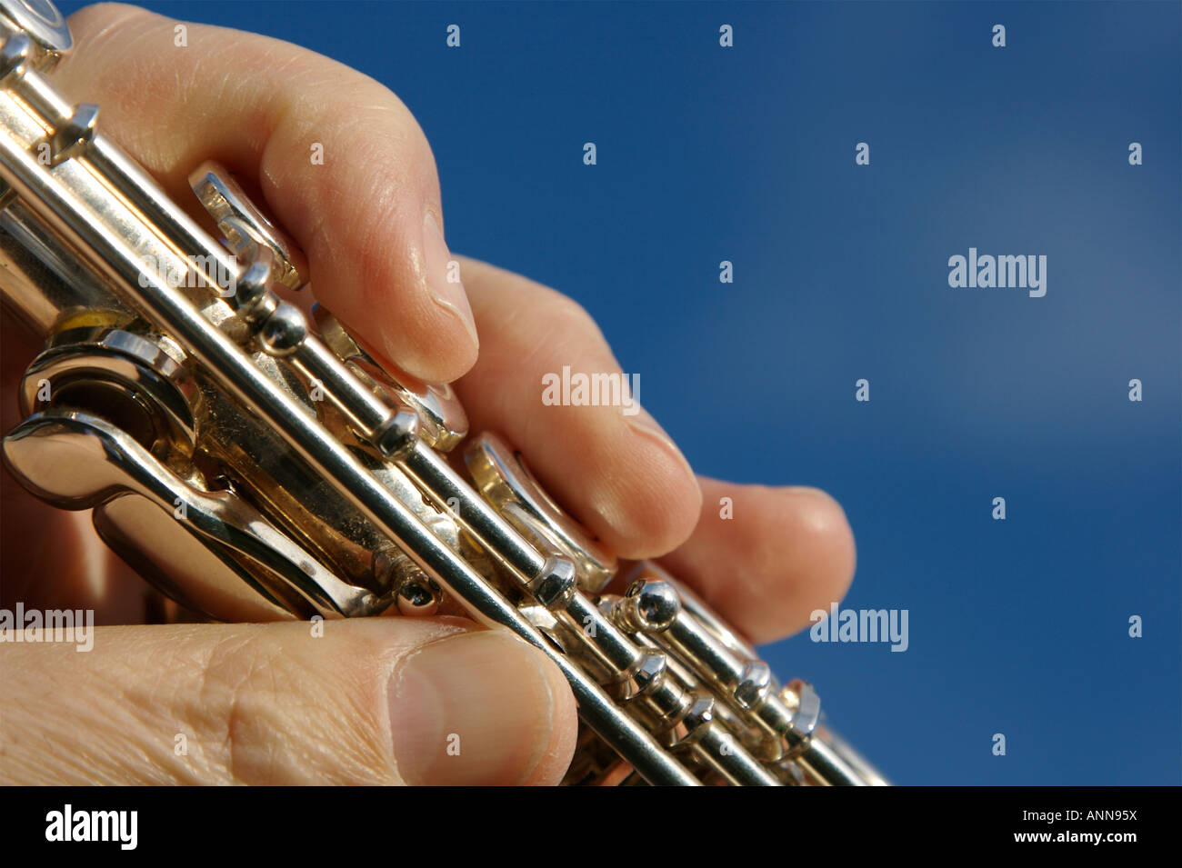 A flautist prepares to play a silver flute Stock Photo Alamy