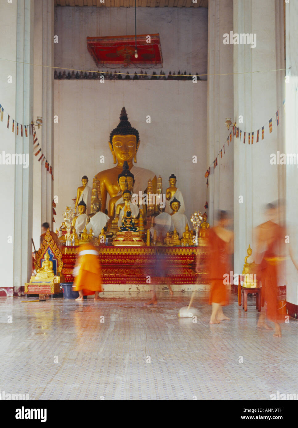 monks cleaning temple, That Luang temple Stock Photo