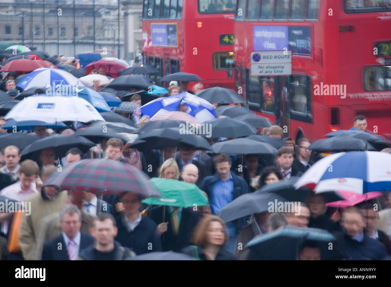 UK London Commutors in the rain on London Bridge Stock Photo