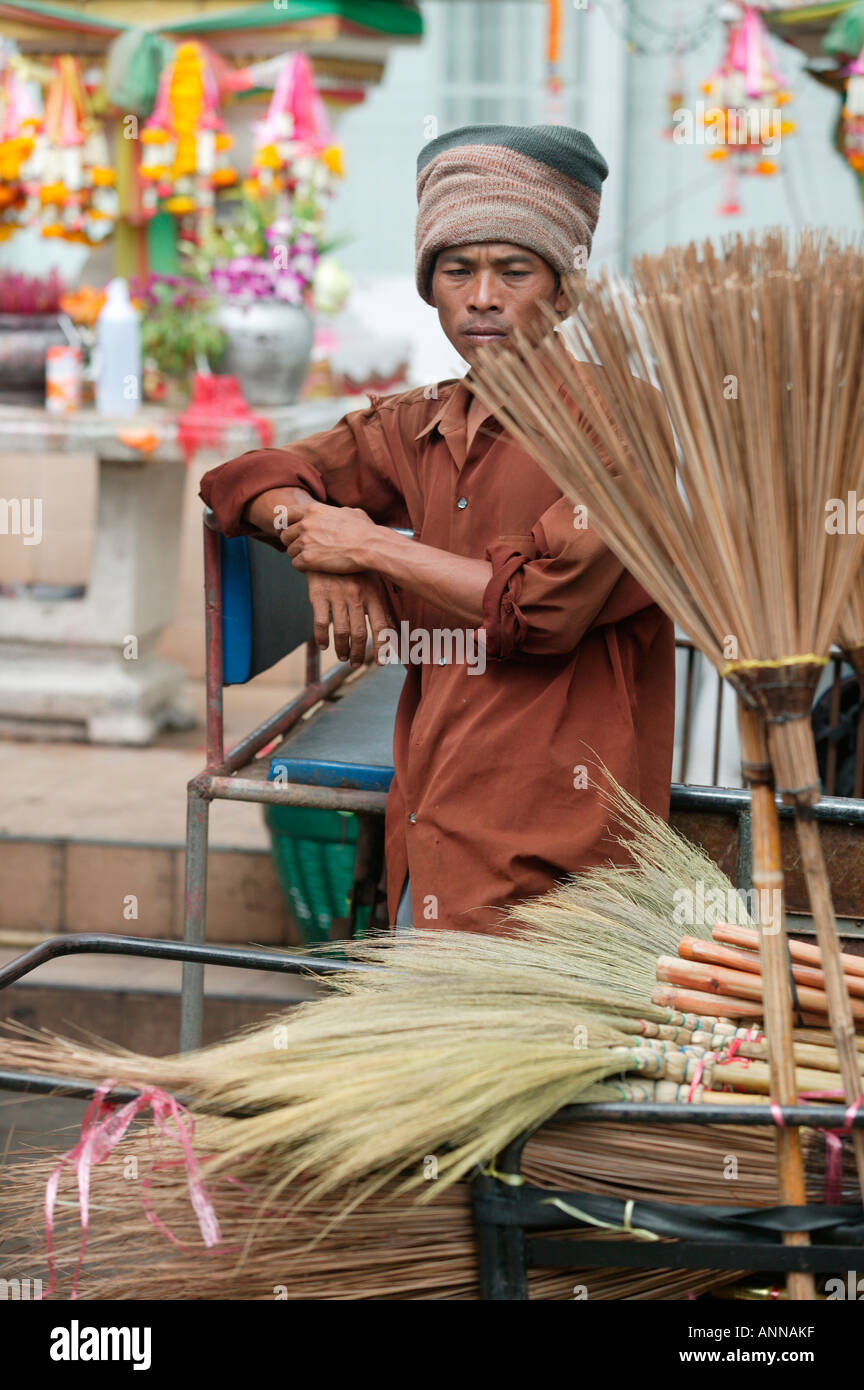 Man selling brooms and brushes in a a market in Khon Kaen Stock Photo