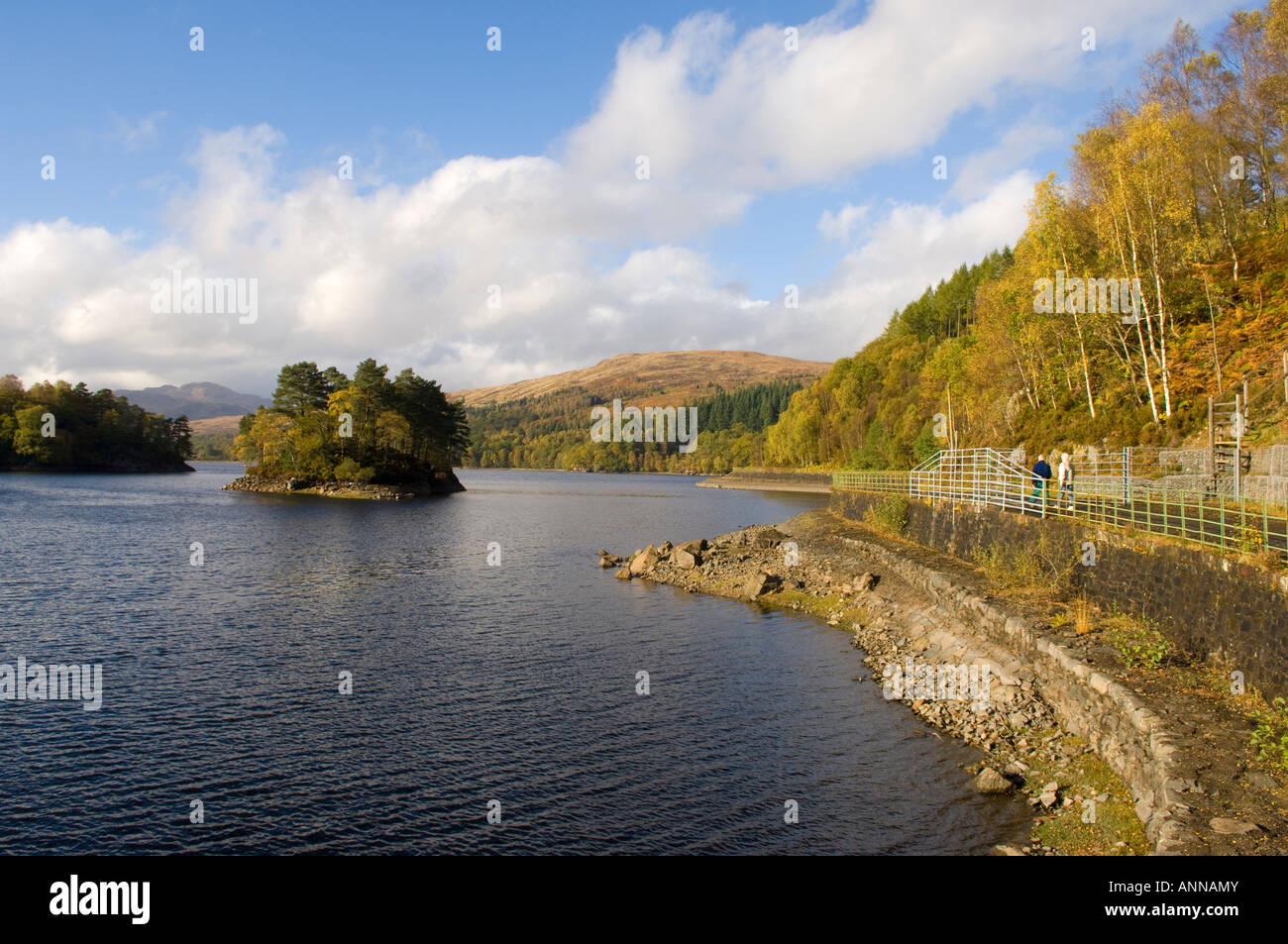 Mature couple walking alongside Loch Katrine, Trossachs National Park