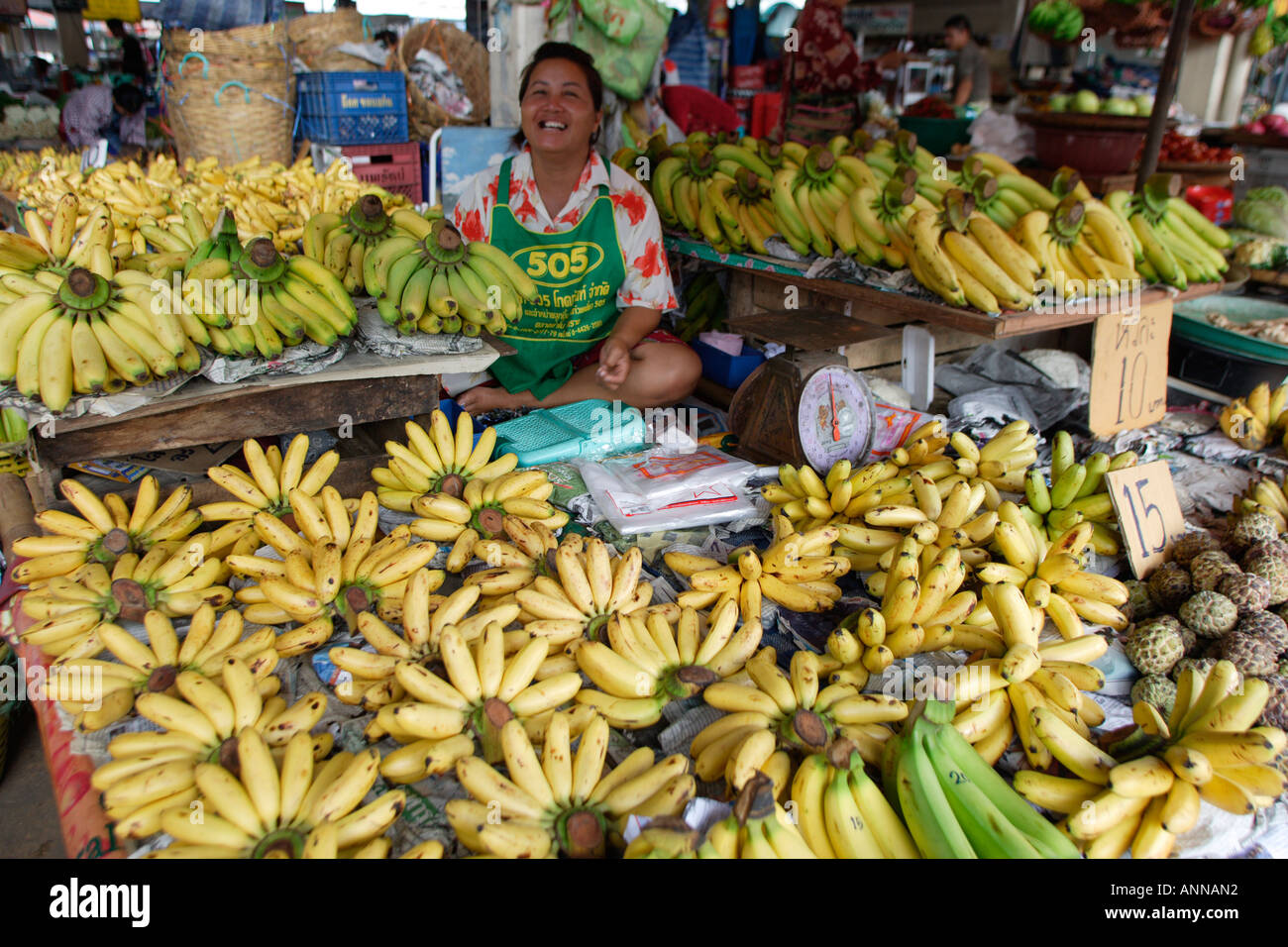 Smiling banana seller at the busy market in Khon Kaen Stock Photo