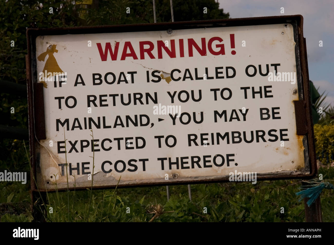 Mainland sign warning against becoming stranded by the tide on Sully Island SE Wales Stock Photo
