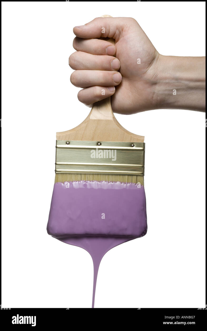 Close-up of a person's hand holding a paintbrush Stock Photo