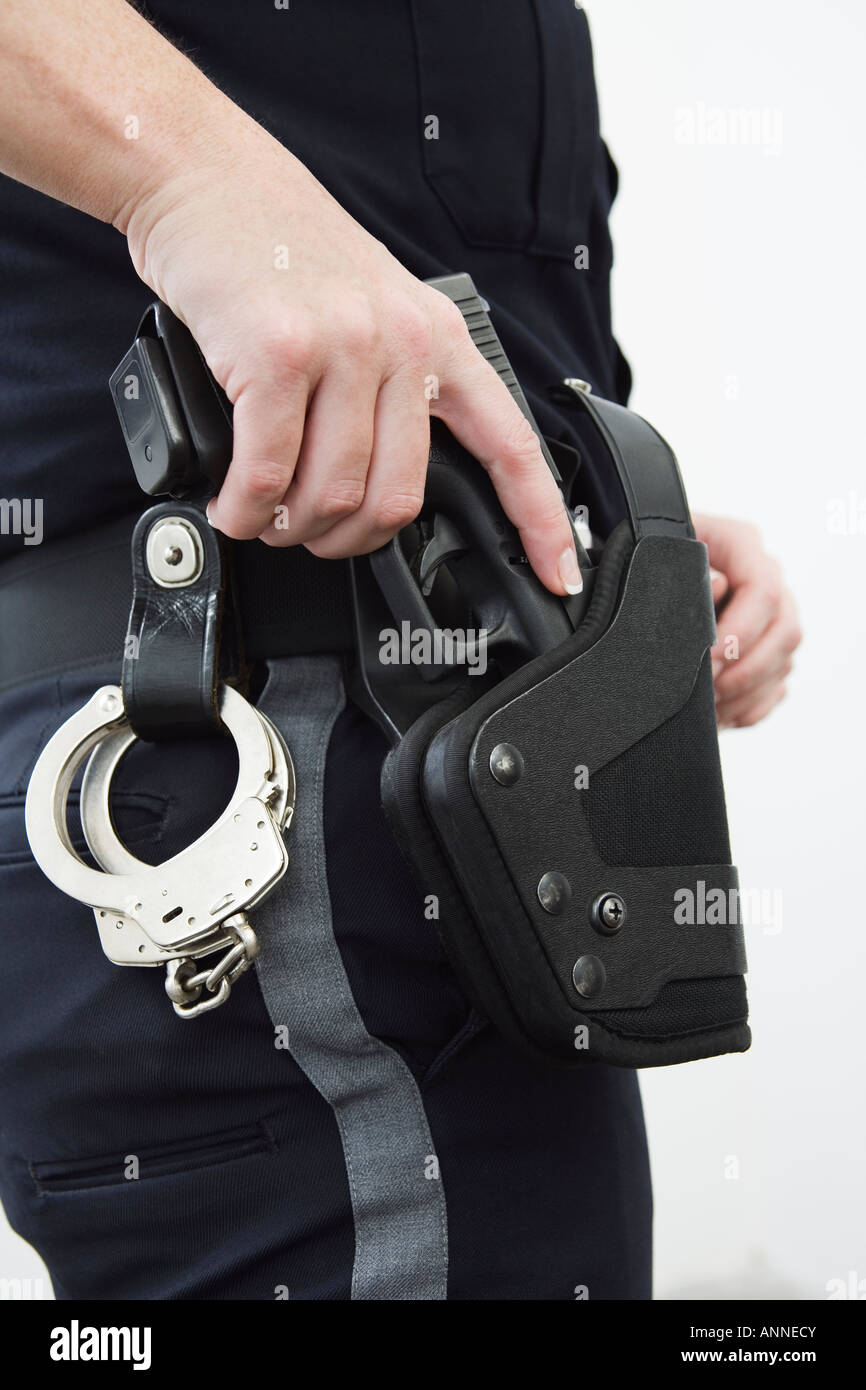 Police woman removing gun from the holster Stock Photo Alamy