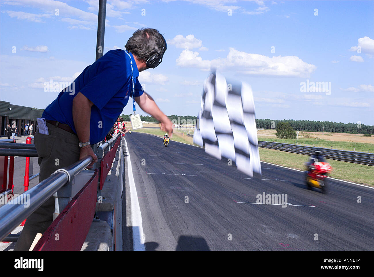 Chequered Flag Being Waved At the End Of a Motorcycle Endurance Race Stock  Photo - Alamy