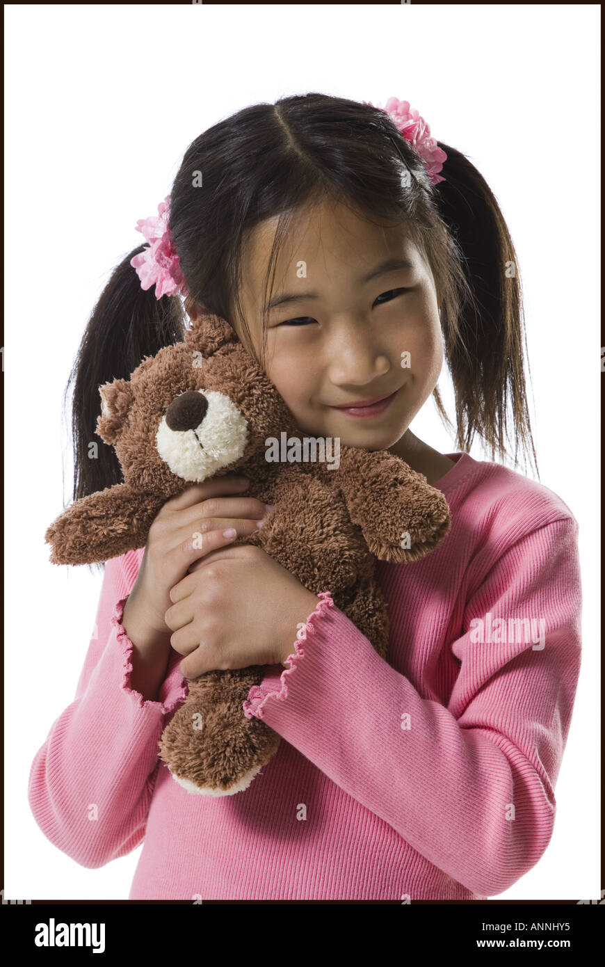 Portrait of a girl holding a teddy bear and smiling Stock Photo
