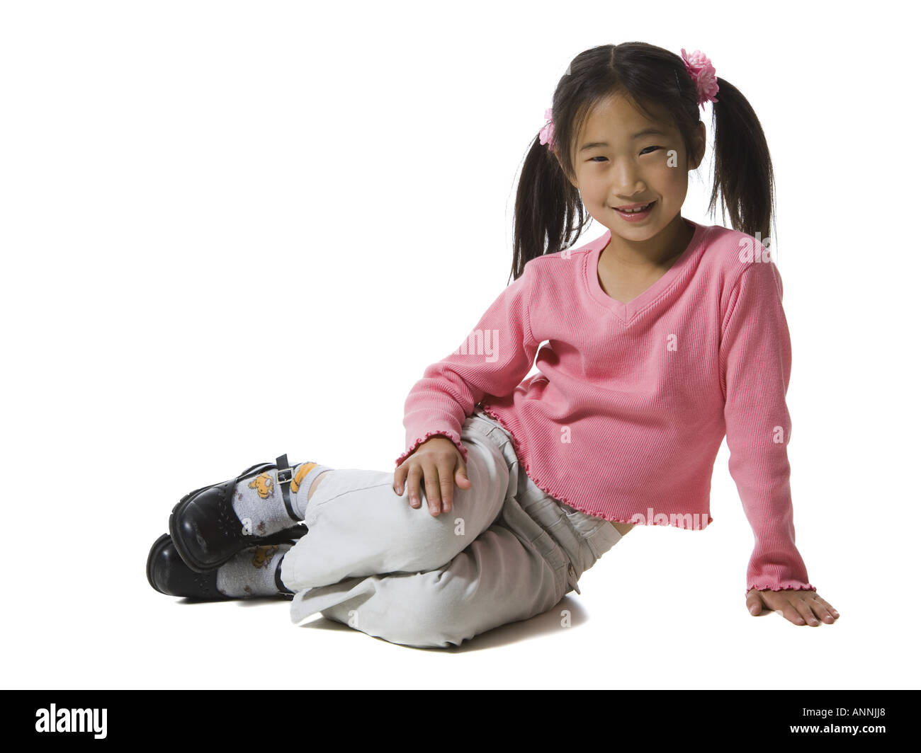Portrait of a girl sitting on the floor and smiling Stock Photo