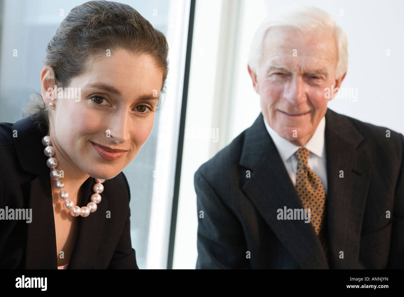Businesspeople smiling in an office Stock Photo - Alamy
