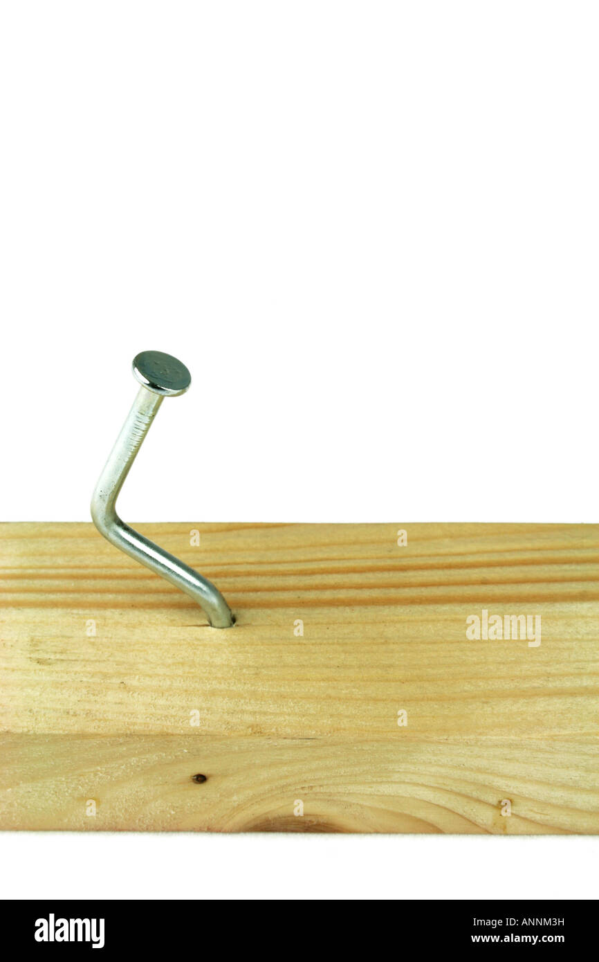 bent nail hammered into wooden batten Stock Photo