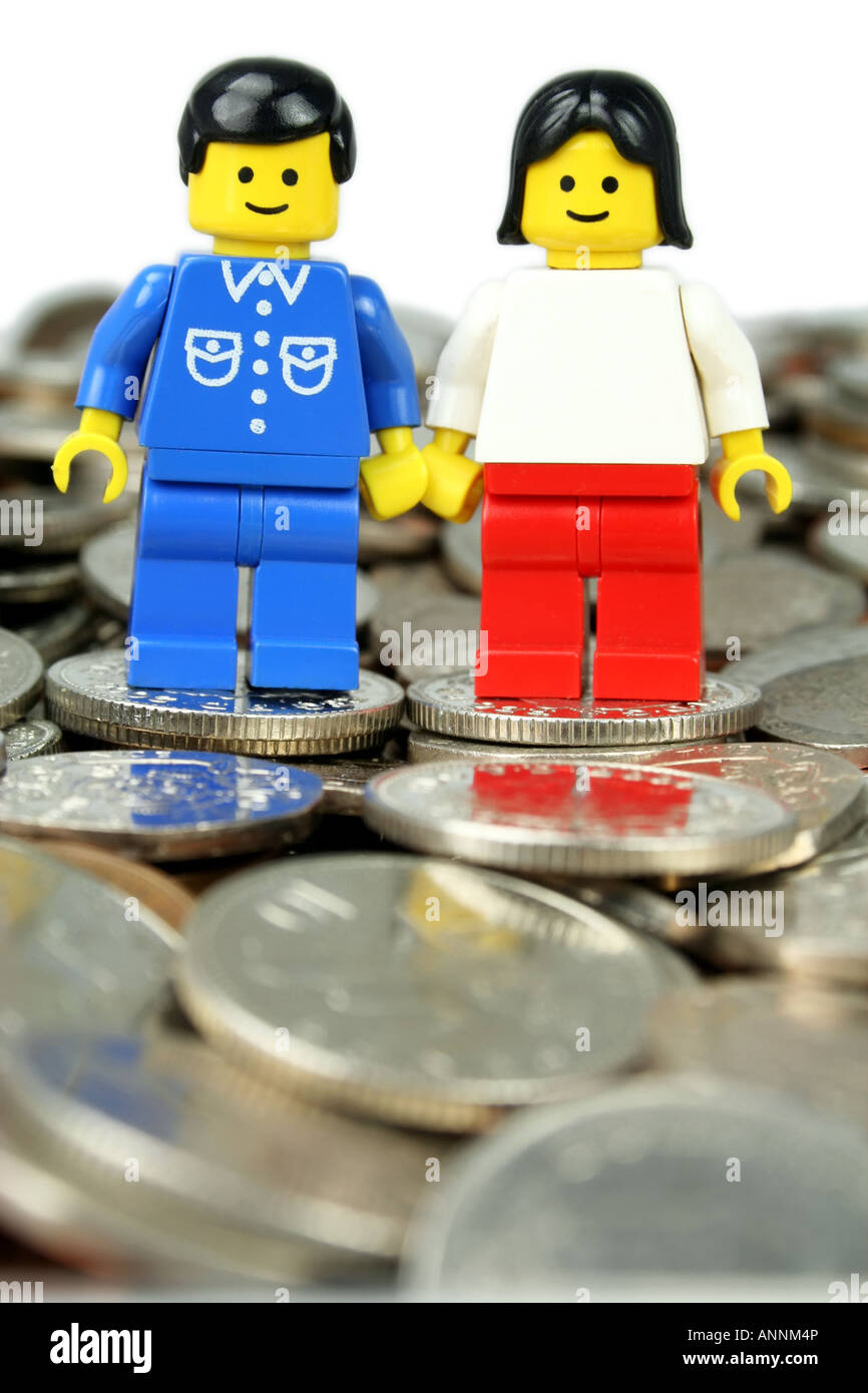 Lego man and woman standing on coins - 'in the money' concept Stock Photo