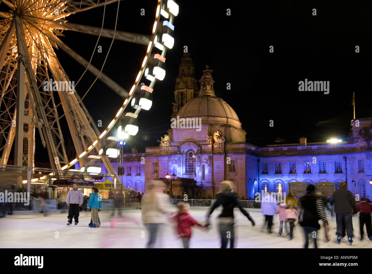 Horizontal wide angle of people having fun ice skating on the open air