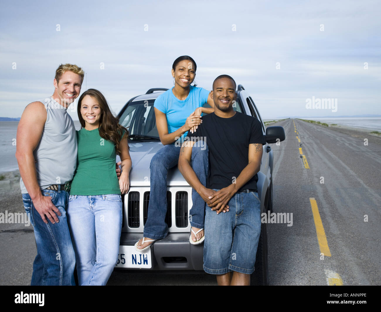 Portrait of a mid adult man and a young man smiling with two young ...