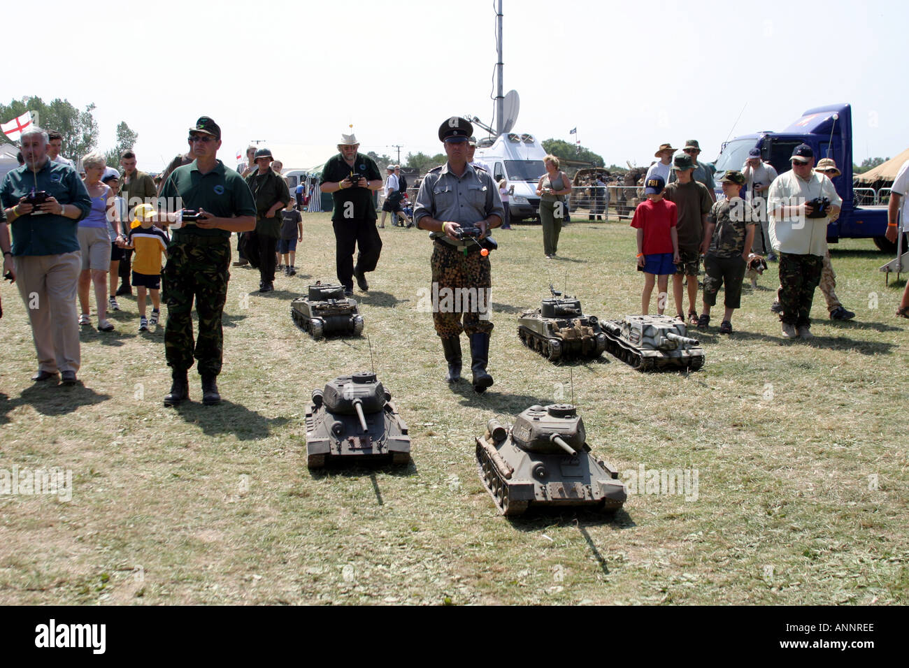 Group of old men walking their remote control tanks Stock Photo