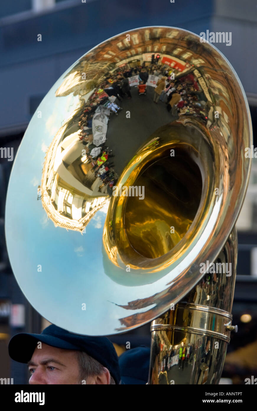 Vertical close up of the bell of a huge sousaphone aka marching tuba, being played by a man in a marching brass band. Stock Photo