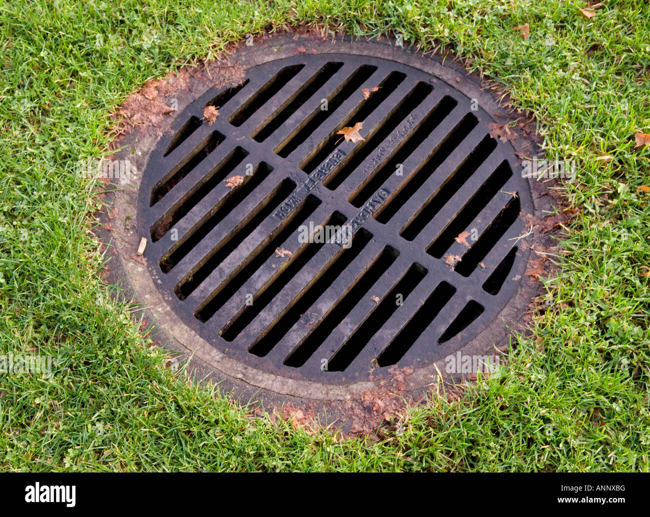 Storm sewer drain in a grassy area Stock Photo