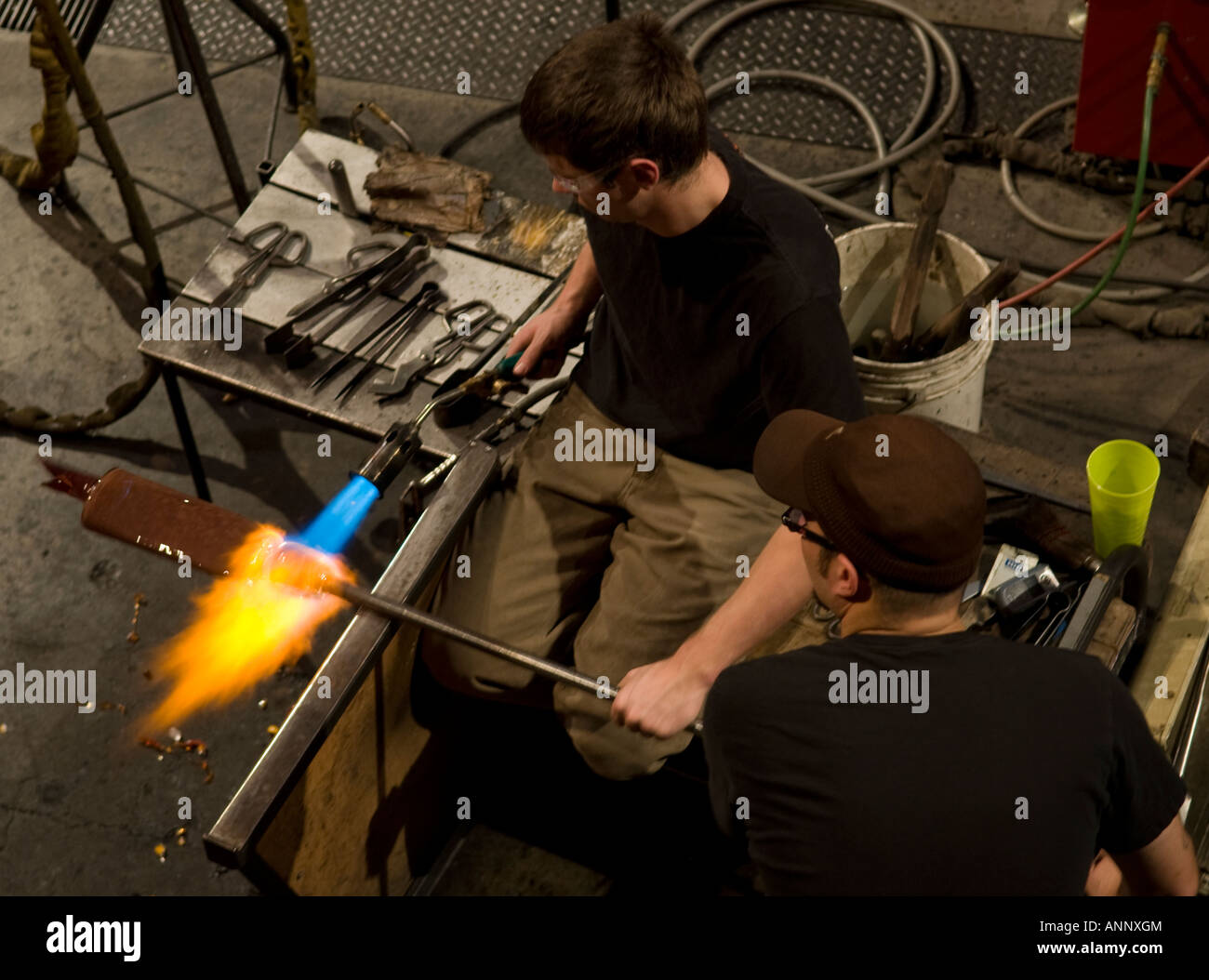 Glassblowers creating blown glass art in the Jane Russell Hot Shop at