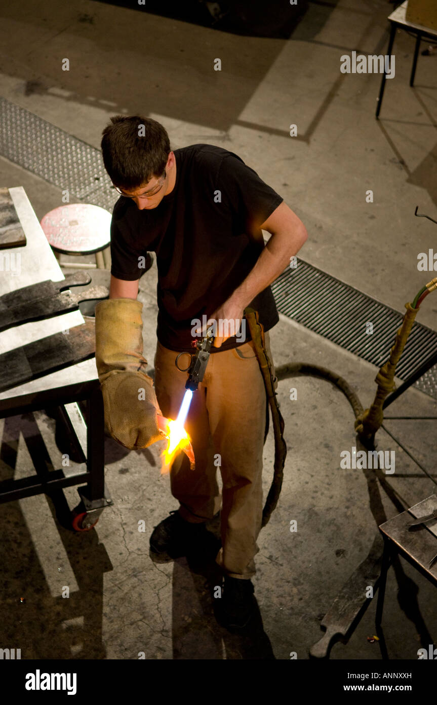 Glassblower creating blown glass art in the Jane Russell Hot Shop at