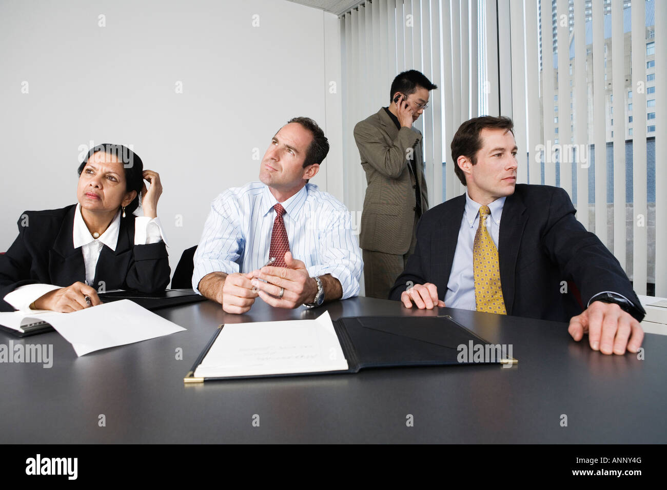 View of businesspeople thinking in an office Stock Photo - Alamy