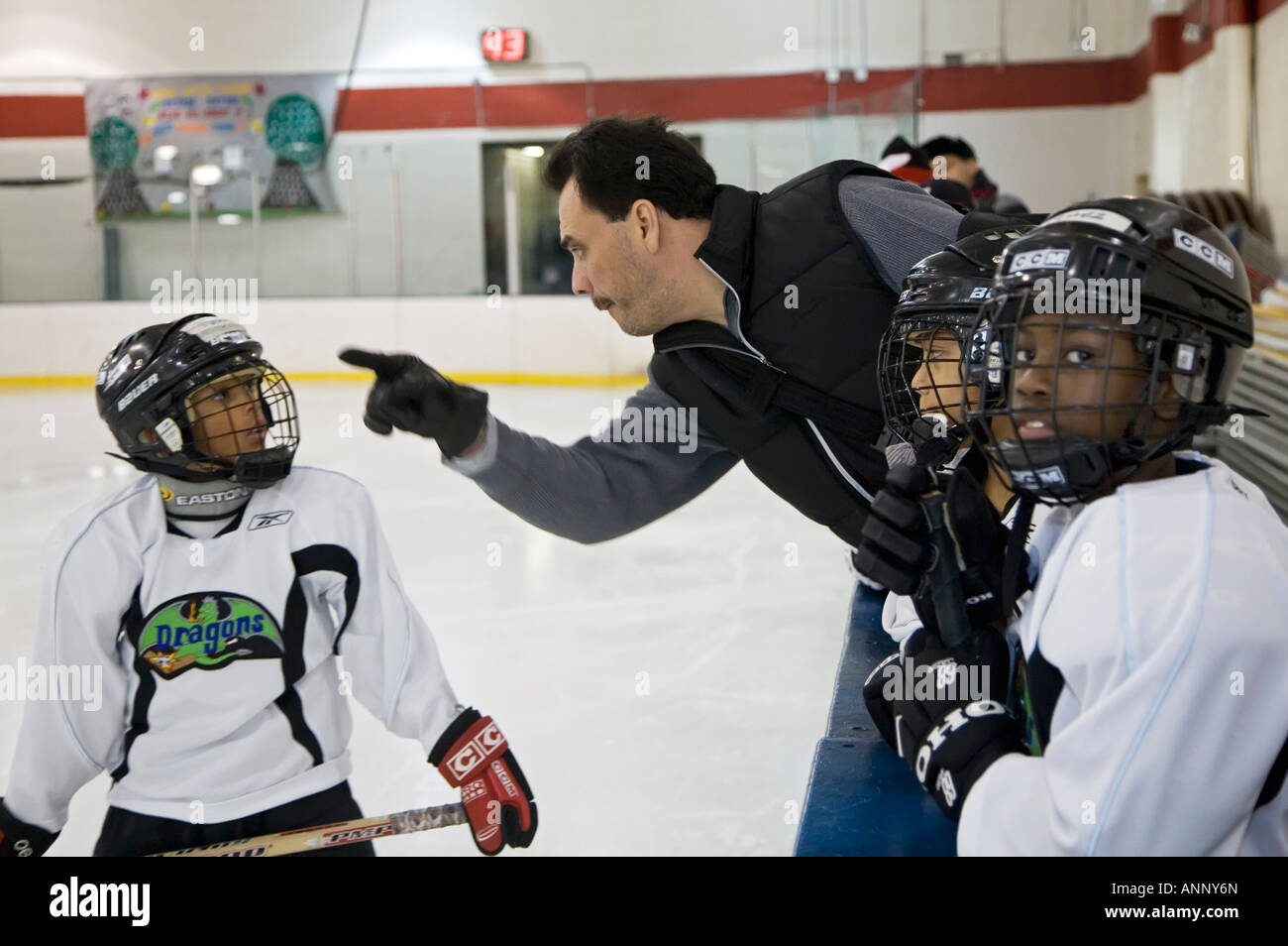 Coach talks to player on youth ice hockey team Stock Photo Alamy