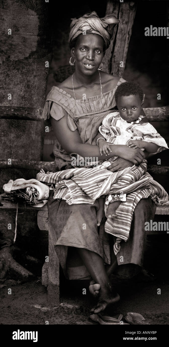 Sepia toned candid portrait of a Gambian African mother and baby. Stock Photo
